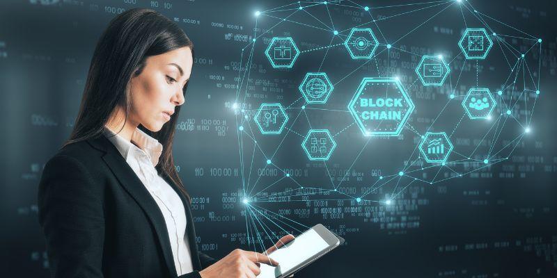 Woman-looking-at-tablet-to-explore-blockchain-technology