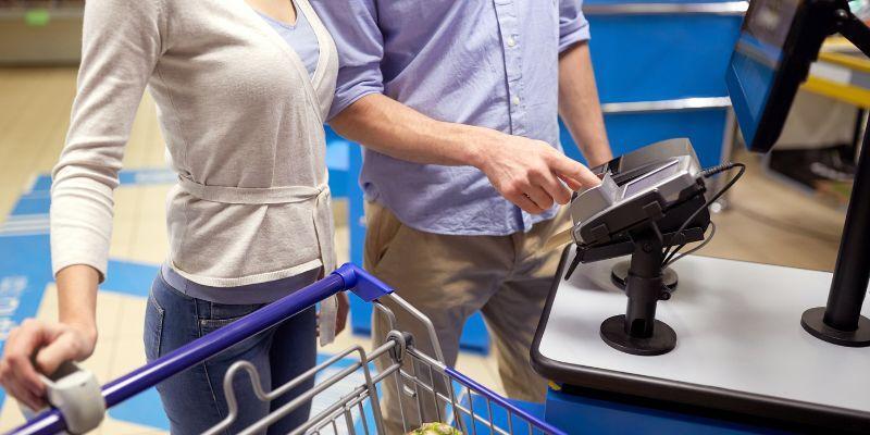 A-couple-using-self-checkout- at-a-retail-store