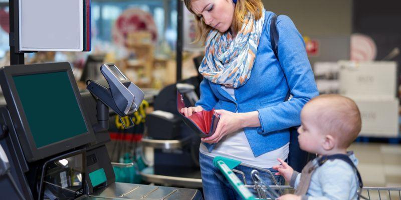 A-mother-using-self-checkout-at-a-retail-store