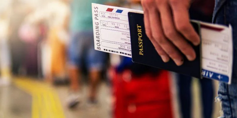 an-airport-passenger-holding-passport-and-boarding-pass