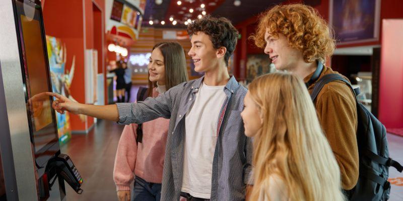 teenagers-using-cinema-self-service kiosk